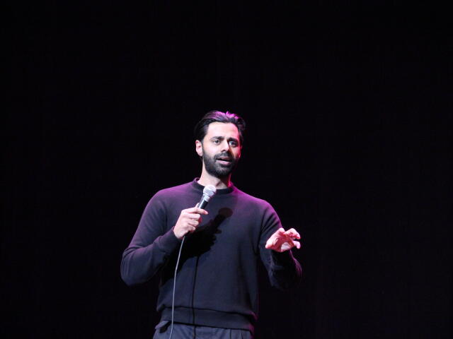 Photo of comedian Hasan Minhaj during a stand up performance